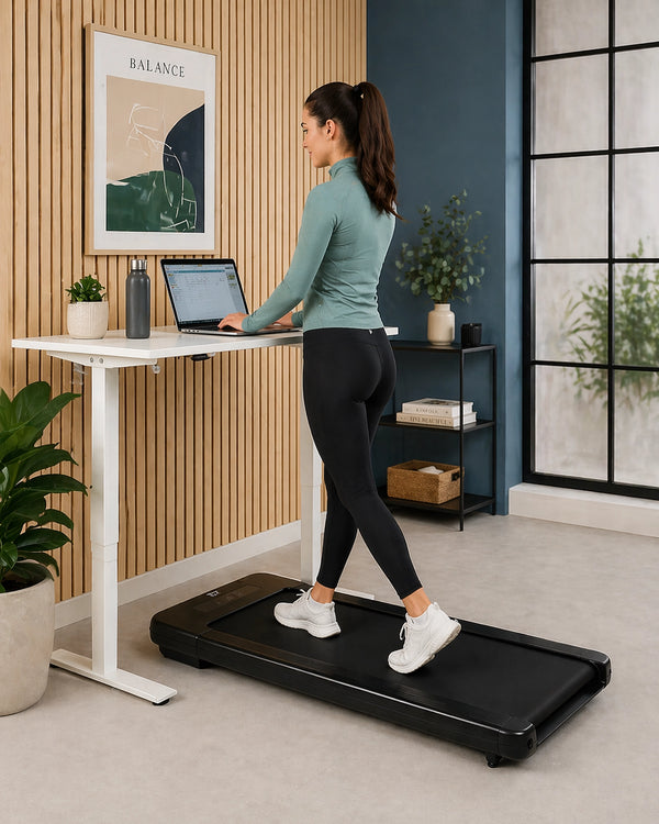 JTX MoveLight walking treadmill under a standing desk in a compact UK home office