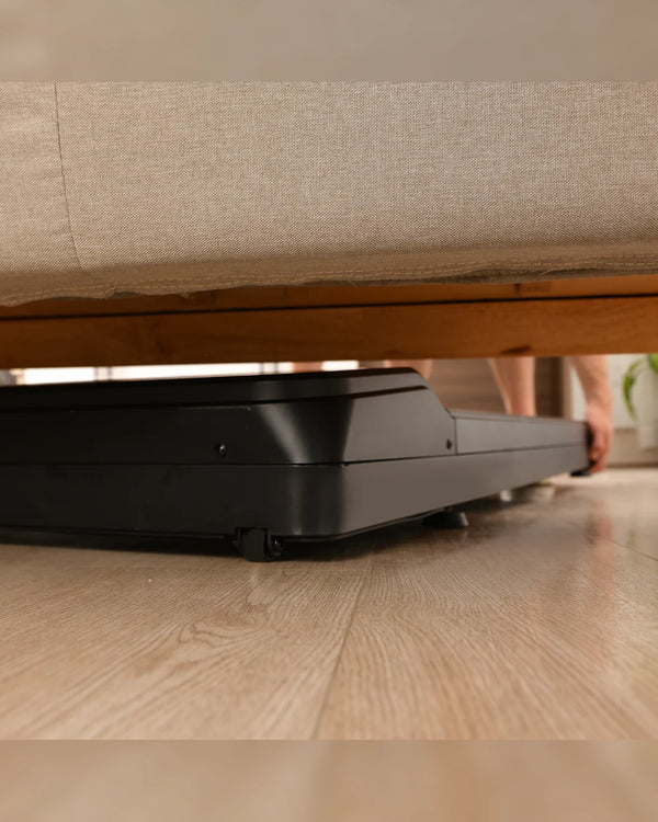 LifeSpan TR1200 pro under-desk treadmill stored neatly under a sofa for compact UK home storage
