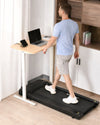 LifeSpan TR1200 pro under-desk treadmill in use with a standing desk for UK home office walking