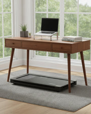 Under-desk walking pad beneath a walnut desk in a bright UK home office