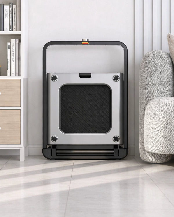 WalkingPad X21 double fold treadmill stored upright in a neutral premium UK living room