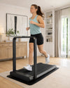 Woman using the WalkingPad X21 in upright running mode in a bright premium UK living room