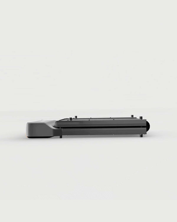 WalkingPad Z1 foldable walking treadmill folded for storage under a sofa