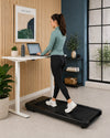 JTX MoveLight walking treadmill under a standing desk in a compact UK home office