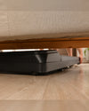 LifeSpan TR1200 pro under-desk treadmill stored neatly under a sofa for compact UK home storage