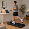 Man running on a walk and run treadmill in a bright modern home office