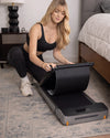 WalkingPad Z1 foldable walking treadmill being folded for compact storage